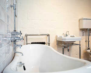 Frosted glass door with the logo "Distinct Bathrooms" and an image of a bathroom fixture.